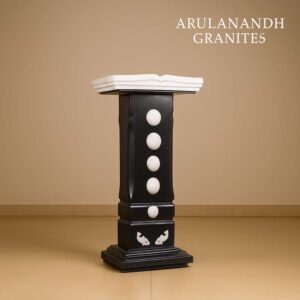 Granite Bible stand with sculpted book top and white inlays.